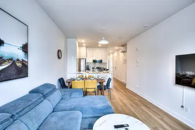 a living room with a blue couch and a table at Beautiful & New! Renovated for your Style Comfort in Montréal