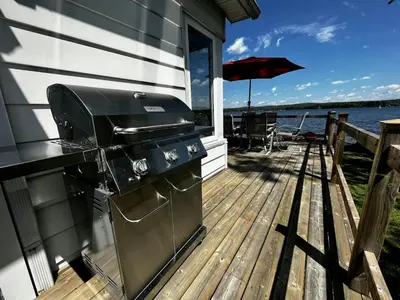 a grill on the deck of a house at La Cozy O-Lac Magog in Sherbrooke