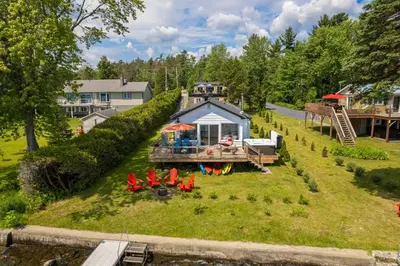 an aerial view of a tiny house on a river at La Cozy O-Lac Magog in Sherbrooke