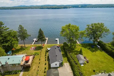an aerial view of a house on the shore of a lake at La Cozy O-Lac Magog in Sherbrooke