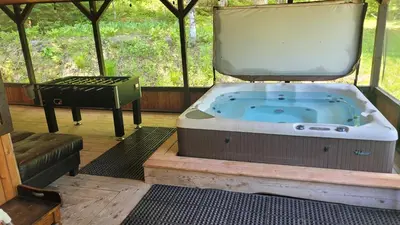 a hot tub in a gazebo with a grill at Spa Nature Estrie in Saint-Herménégilde