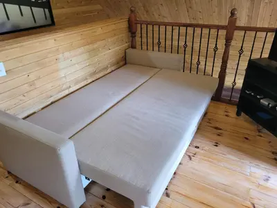 a bed in the corner of a room at Spa Nature Estrie in Saint-Herménégilde