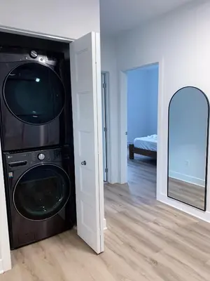 a room with a washing machine and a mirror at 10 minutes to DT with Free parking in Longueuil