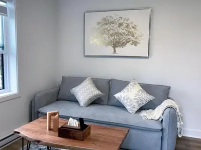 a living room with a blue couch and a table at 10 minutes to DT with Free parking in Longueuil