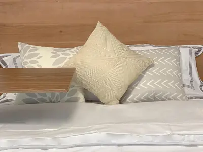 a bed with white sheets and pillows on it at 10 minutes to DT with Free parking in Longueuil