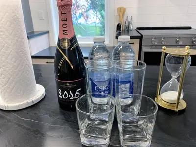 a bottle of wine and two glasses of water on a counter at 10 minutes to DT with Free parking in Longueuil