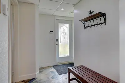 a hallway with a bench next to a door at La vie O-Lac Magog in Sherbrooke