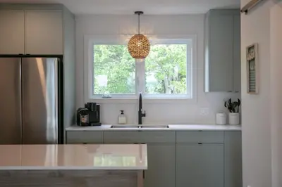 a kitchen with a sink and a window at La Vue O-Lac Magog in Sherbrooke
