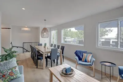 a dining room and living room with a table and chairs at La Vue O-Lac Magog in Sherbrooke