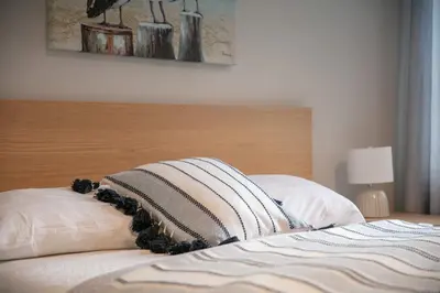 a bed with two pillows on top of it at La Vue O-Lac Magog in Sherbrooke