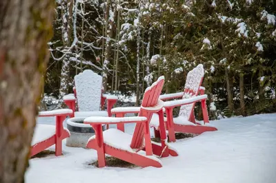 a group of red chairs in the snow at La Vue O-Lac Magog in Sherbrooke