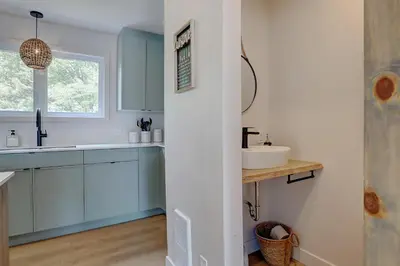 a bathroom with blue cabinets and a sink at La Vue O-Lac Magog in Sherbrooke