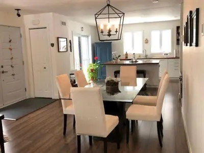 a kitchen and dining room with a table and chairs at Rooms in peaceful nature settings in Sutton