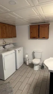 a bathroom with a toilet and a sink at Spacious basement apartment in Montréal