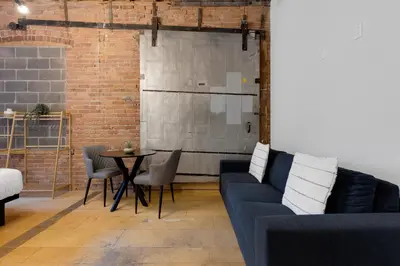 a living room with a blue couch and a table at The Little Prince Rooms-Old Montreal in Montréal