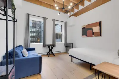 a living room with a bed and a couch at The Little Prince Rooms-Old Montreal in Montréal