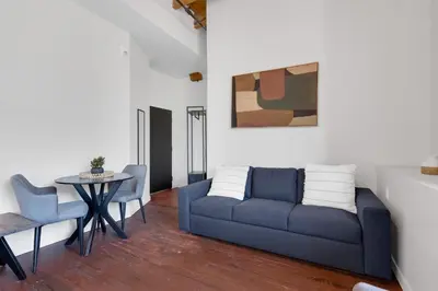 a living room with a blue couch and a table at The Little Prince Rooms-Old Montreal in Montréal