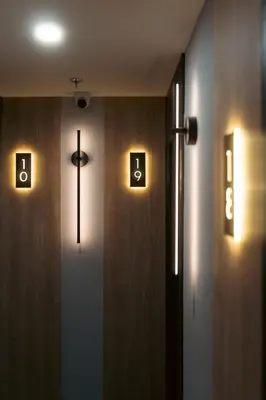 a hallway with a door with a cross and lights at Lift Hotel in Montréal