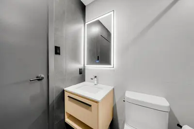 a bathroom with a white toilet and a sink at Lift Hotel in Montréal