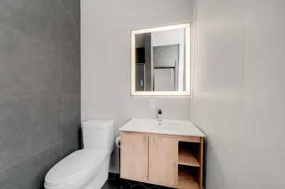 a bathroom with a white toilet and a sink at Lift Hotel in Montréal