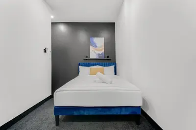 a bedroom with a blue and white bed at Lift Hotel in Montréal