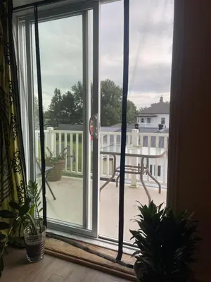 an open window with a view of a balcony at Auberge Le Wagon in Wotton