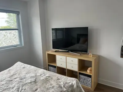 a bedroom with a bed and a television on a stand at Luna's Room in Longueuil