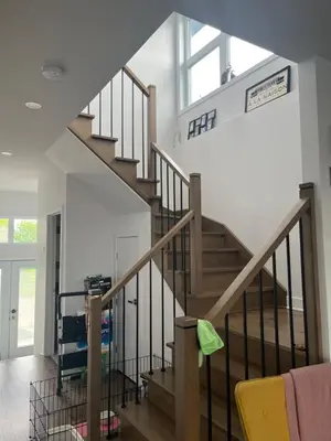 a staircase in a living room with a window at Luna's Room in Longueuil
