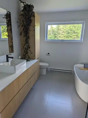a bathroom with a sink and a tub and a toilet at 4 bedrooms New House in Farnham