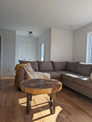 a living room with a couch and a coffee table at 4 bedrooms New House in Farnham