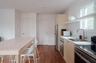 a white kitchen with a sink and a counter top at Chalet 1 OST Shefford in Shefford