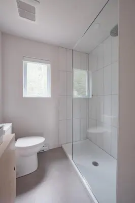 a white bathroom with a shower and a toilet at Chalet 1 OST Shefford in Shefford