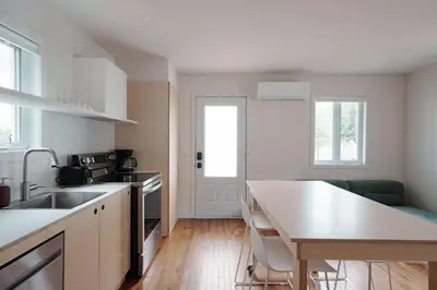 a kitchen with a sink and a table in it at Chalet 2 OST Shefford in Shefford