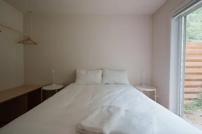 a white bed in a room with a window at Chalet 4 OST Shefford in Shefford