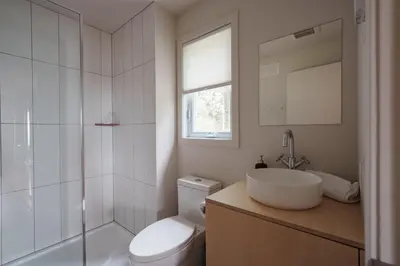 a bathroom with a toilet and a sink and a shower at Chalet 4 OST Shefford in Shefford