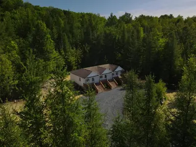 an aerial view of a house in the middle of a forest at Chalet 5 OST Shefford in Shefford