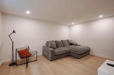 a living room with a couch and a chair at Chalet 5 OST Shefford in Shefford