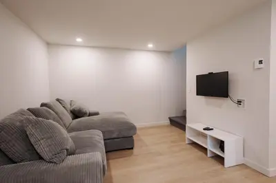 a living room with a couch and a flat screen tv at Chalet 6 OST Shefford in Shefford