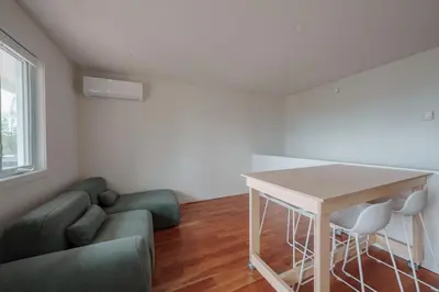 a living room with a couch and a table at Chalet 6 OST Shefford in Shefford