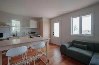 a kitchen and living room with a green couch at Chalet 6 OST Shefford in Shefford