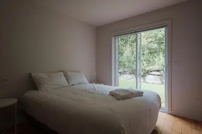 a bedroom with a bed and a large window at Chalet 6 OST Shefford in Shefford