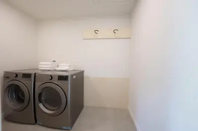 a washer and dryer in a white room at Chalet 3 OST Shefford in Shefford