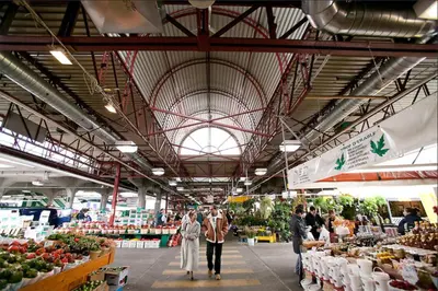 a group of people walking through a farmers market at Renovated 2-Bedroom Haven by Jean Talon Market in Montréal