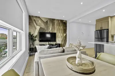 a living room with a couch and a table at Renovated 2-Bedroom Haven by Jean Talon Market in Montréal