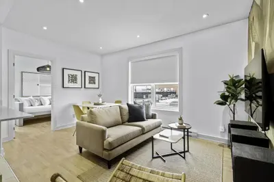 a living room with a couch and a table at Renovated 2-Bedroom Haven by Jean Talon Market in Montréal