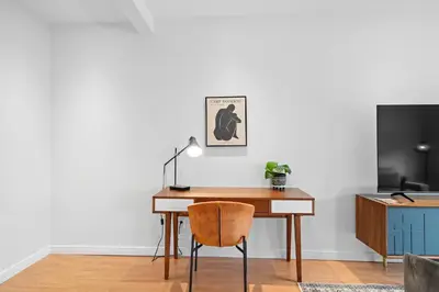 a desk with a chair next to a tv at Trendy 2-Bedroom Haven by Jean Talon Market in Montréal