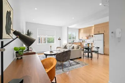 a living room with a couch and a table at Trendy 2-Bedroom Haven by Jean Talon Market in Montréal