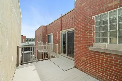 an empty balcony of a brick building at Trendy 2-Bedroom Haven by Jean Talon Market in Montréal