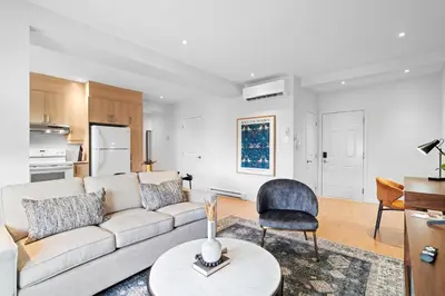 a living room with a couch and a chair at Trendy 2-Bedroom Haven by Jean Talon Market in Montréal