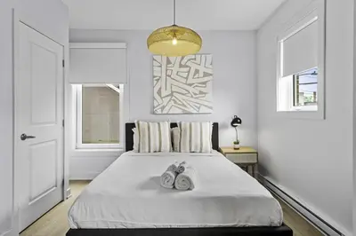a bedroom with a bed with two towels on it at Stylish 1-Bedroom Haven by Jean Talon Market in Montréal
